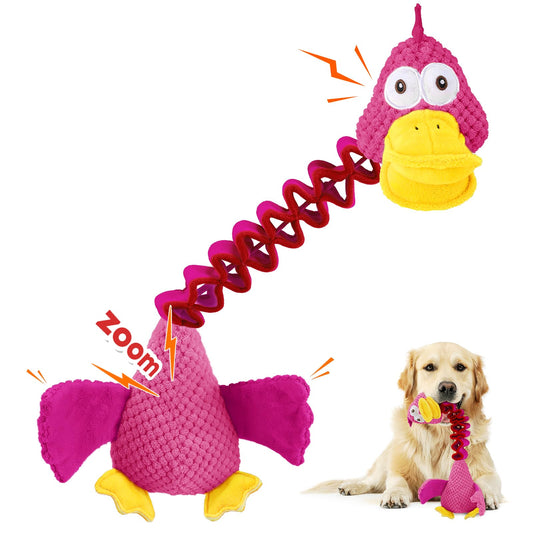 Pink and yellow bird-shaped dog toy with a spring mechanism, featuring a dog playing with it.